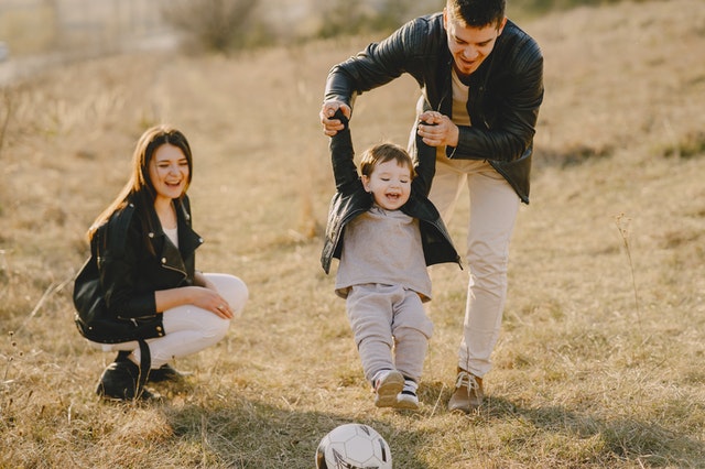 Happy family playing with their young child.