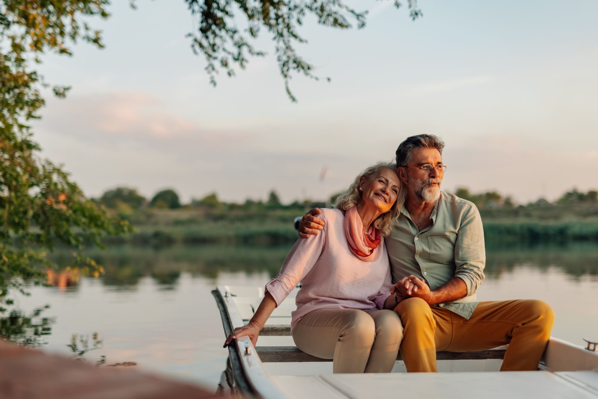 Senior couple looking sitting in a boat looking away